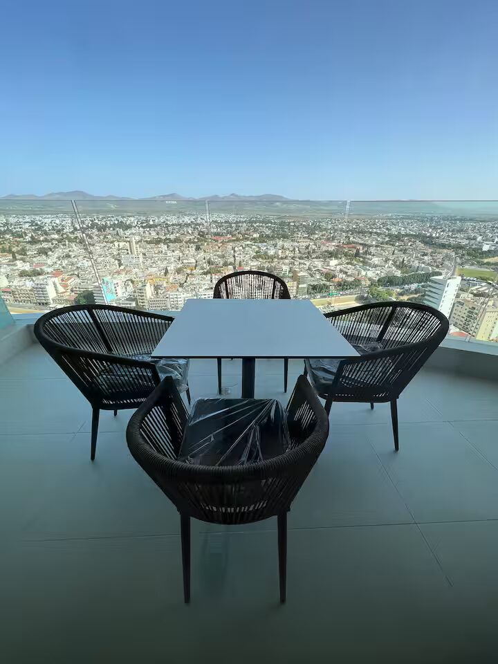 Balcony table and chairs high above the city