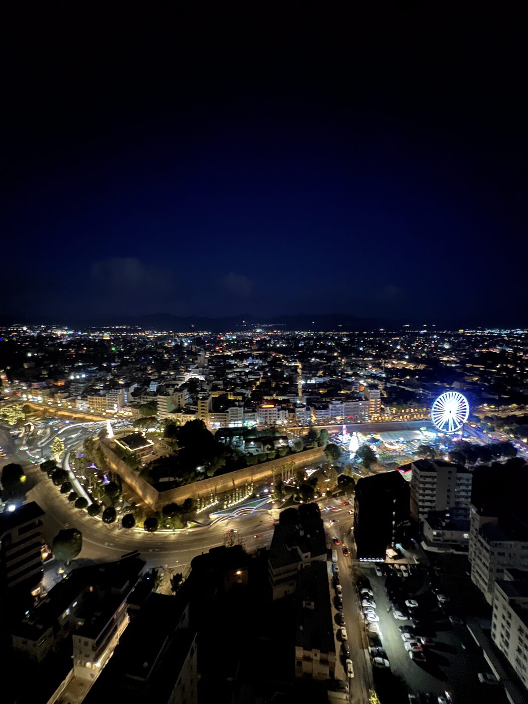 Night panorama from the balcony, with the ferris wheel glowing below