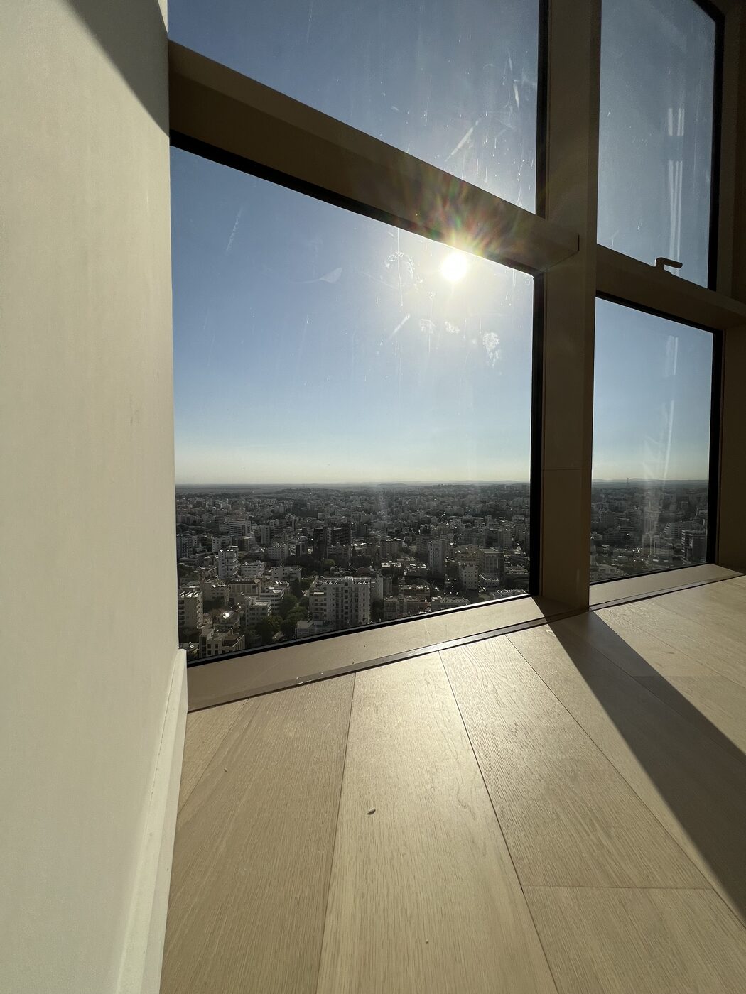 Sunlight over the city through the second bedroom window