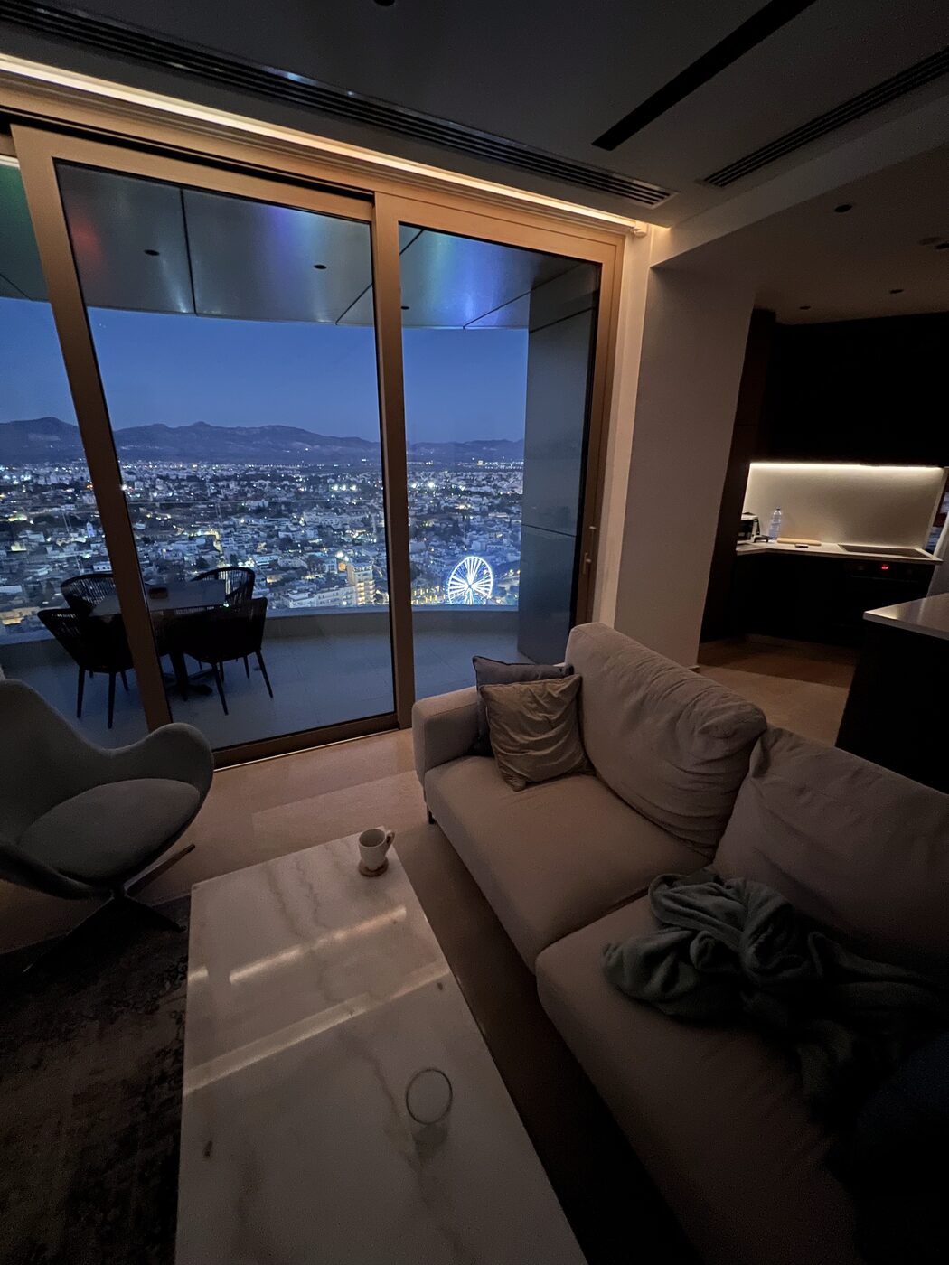 The living room at night, city lights below